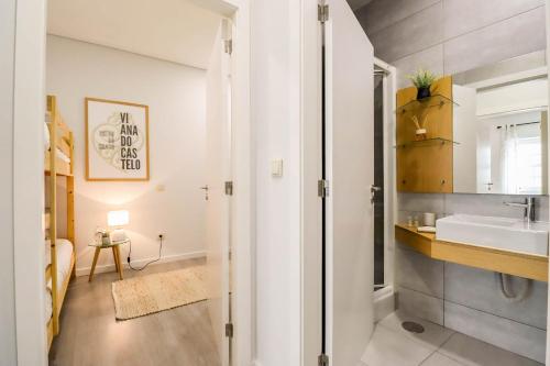 a bathroom with a sink and a mirror at Viana Central - Historical City Centre Apartment in Viana do Castelo