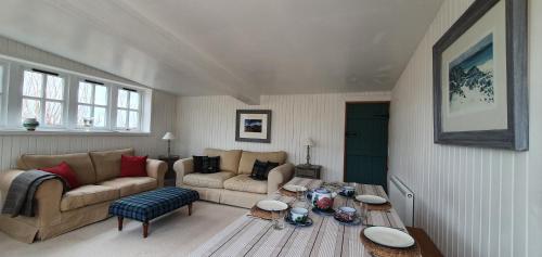 a living room with a couch and a table at The Loan in Achiltibuie