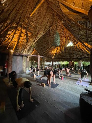 a group of people doing yoga in a building at Sueños Tulum in Tulum
