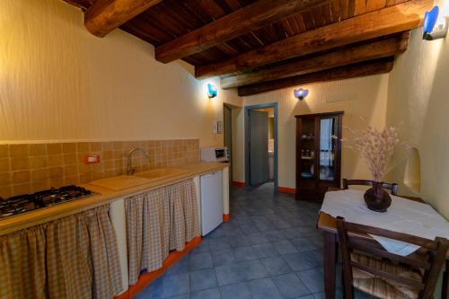 a kitchen with a sink and a stove top oven at Solares Case Vacanze in Ustica