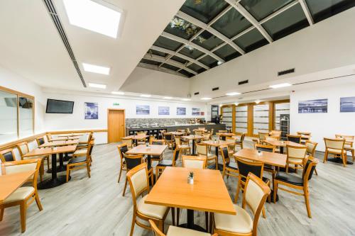 a dining room with wooden tables and chairs at Archibald City in Prague