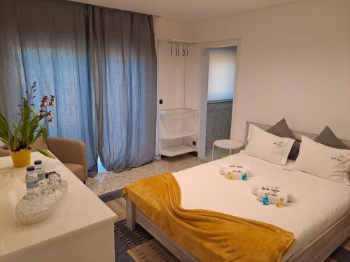 a bedroom with a bed and a table with bottles on it at Quinta Salinas - Puro Prazer in Aveiro