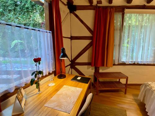 a desk in a room with a window and a table at Casa Magnolia in Cumbayá