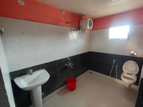 a bathroom with a sink and a toilet at Hotel Geetanjali Palace in Kalyani