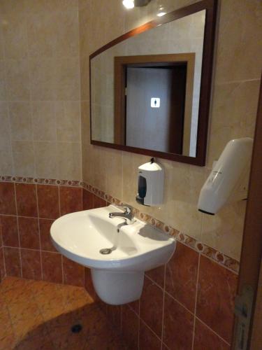 a bathroom with a sink and a mirror at Sunny Flower Family Hotel in Sunny Beach