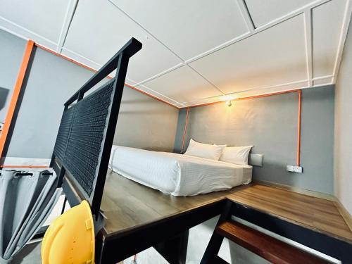 a small room with a bed and a desk at Ardour Lodge "A" Wing in Tanjung Bungah