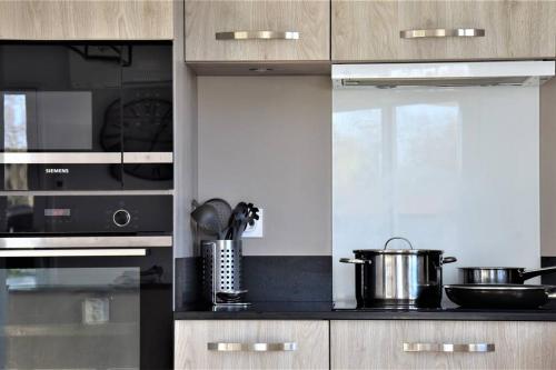 a kitchen with a stove and a pot on the counter at Calm house, swimming pool and garden in Bénesse-Maremne