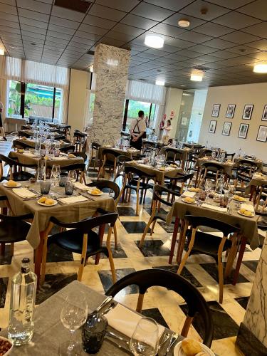 a dining room with tables and chairs with glasses on them at Turia Valencia in Valencia