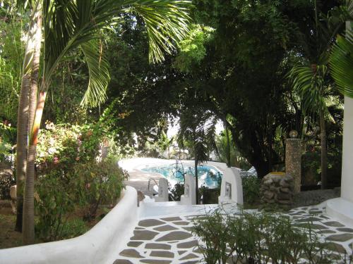 a resort with a swimming pool and palm trees at Scorpio Villas Resort in Malindi