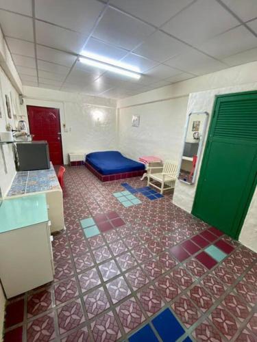 a room with a room with a blue bed in it at Ratanawong Place 206 in Bangkok