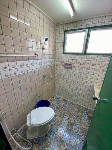 a bathroom with a toilet and a shower at Ratanawong Place 206 in Bangkok
