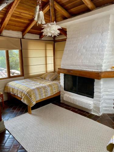a bedroom with a bed and a fireplace at Casa Magnolia in Cumbayá