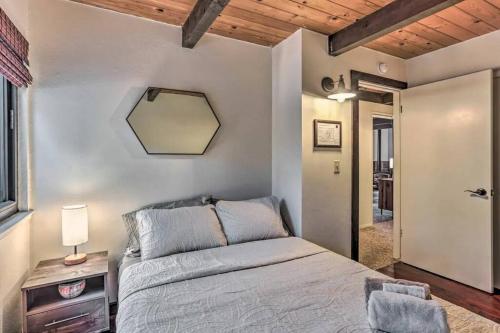 a bedroom with a bed and a mirror on the wall at Peaceful Oak Haven Cabin near Yosemite in Mariposa