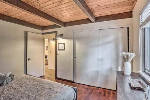 a bedroom with a large bed and a wooden ceiling at Peaceful Oak Haven Cabin near Yosemite in Mariposa