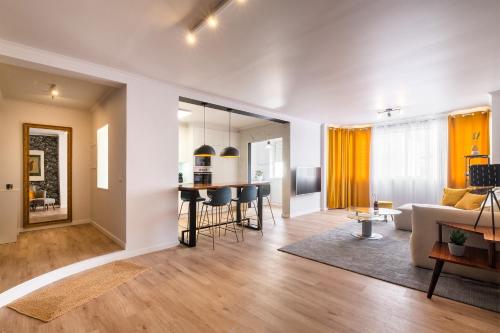 a living room with a couch and a table at Hospitality is an Art - Ponta Delgada City Center in Ponta Delgada