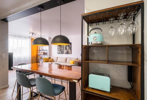 a kitchen and dining room with a table and chairs at Hospitality is an Art - Ponta Delgada City Center in Ponta Delgada