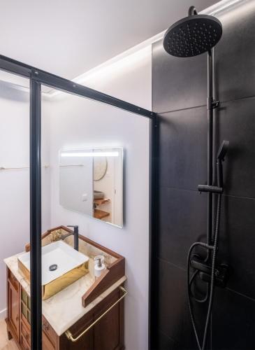 a bathroom with a sink and a shower at Hospitality is an Art - Ponta Delgada City Center in Ponta Delgada