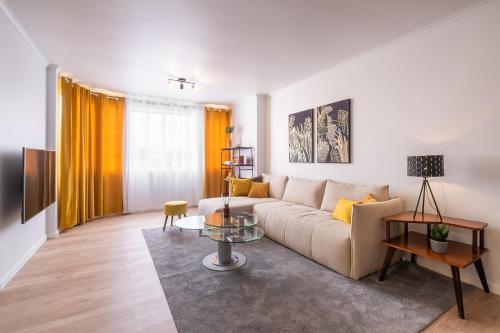 a living room with a couch and a table at Hospitality is an Art - Ponta Delgada City Center in Ponta Delgada