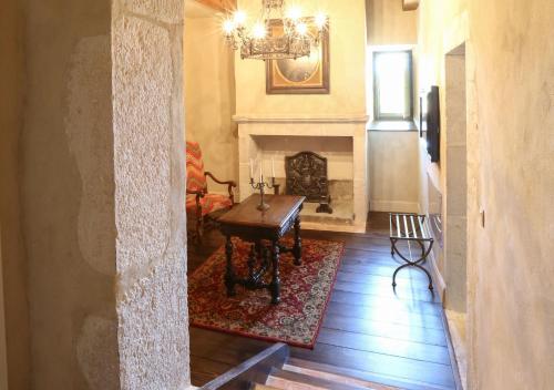 a living room with a table and a fireplace at Château de La Mar Chambres d'Hôtes in Jongieux