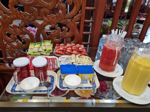 a table with two trays of food and drinks at khampiane hotel in Ban Nongdouang