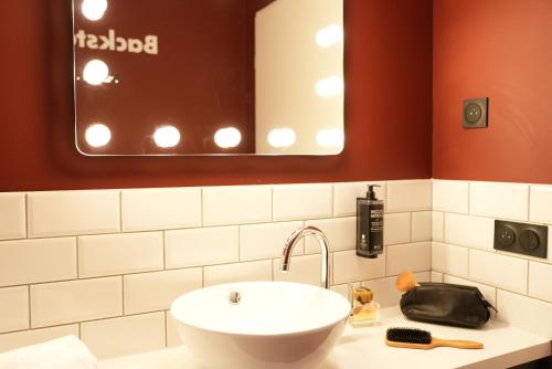 a bathroom with a sink and a mirror at ibis Styles Lens Centre Gare in Lens