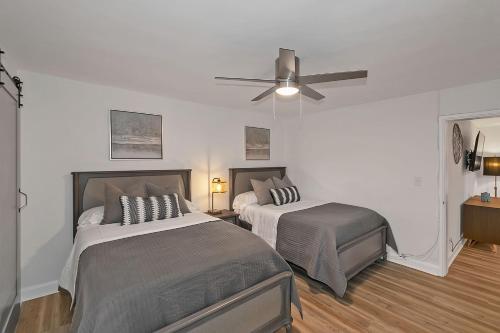 a bedroom with two beds and a ceiling fan at Modern Twist In A Historic Building, Sleeps 6 in Atlanta