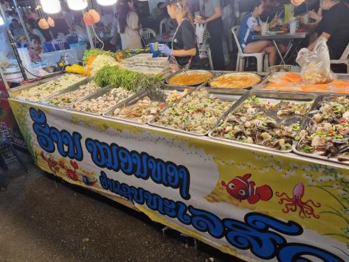 a buffet table with many different types of food on it at Khampiane1 Hotel in Ban Nongdouang