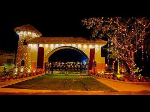 an archway with christmas lights in a building at Raj Kuthir Homestays - Sobuj Potro in Bolpur