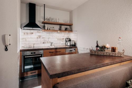 a kitchen with a counter top and a stove at Alpenappartements Cristall in Ehrwald