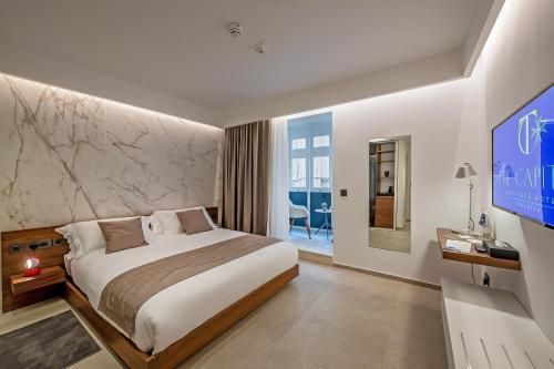 a hotel room with a bed and a tv at The Capital Boutique Hotel in Valletta