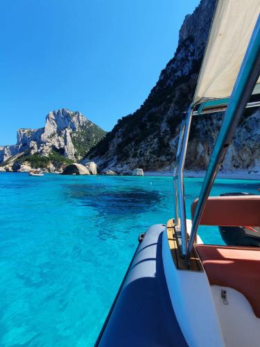 a boat in the water with a view of the ocean at B&B Fradama' Holiday in Dorgali