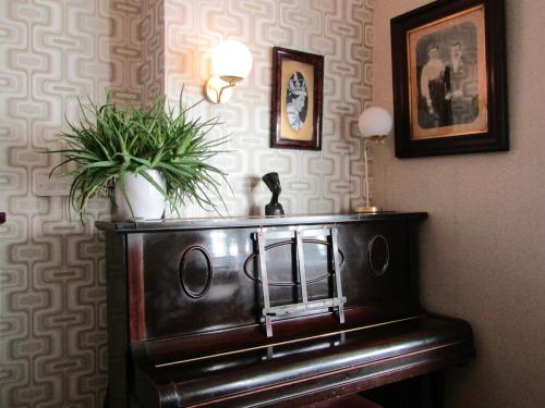 a piano in a room with a potted plant on it at The Scala Hotel in Blackpool