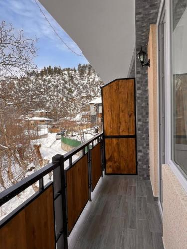 a balcony with a door and a view of the snow at Woodland Borjomi in Borjomi