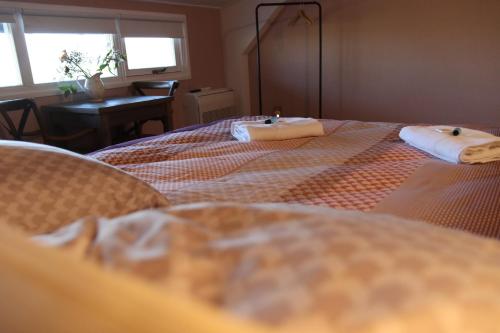 a bedroom with two beds with towels on them at Porcus Campus in Aarle-Rixtel