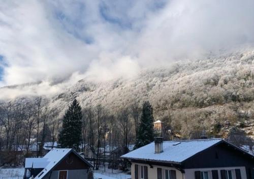 a house in front of a snow covered mountain at Hôtel La Rencluse in Luchon