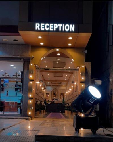 a store front with a sign that reads reception at Najma ApartHotel in Jeddah