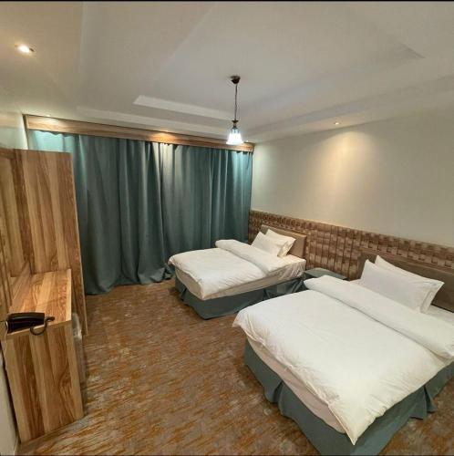 Säng eller sängar i ett rum på Najma ApartHotel