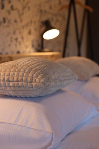 a pillow sitting on top of a bed at Porcus Campus in Aarle-Rixtel