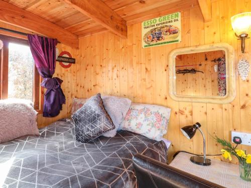 a room with a bed in a tiny house at Packhorse Shepherds Hut in Belper