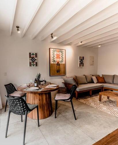 a living room with a couch and a table and chairs at BoHo Home in Gated Eco Residence marAmar - Top location in Santa Teresa Beach