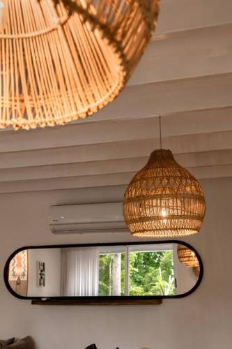 a mirror and a chandelier in a room at BoHo Home in Gated Eco Residence marAmar - Top location in Santa Teresa Beach