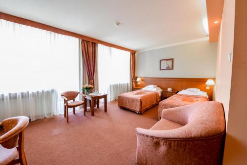 a hotel room with two beds and a window at SPA Hotel Jawor in Jaworze