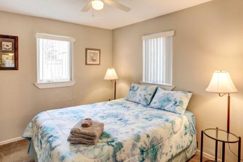 a bedroom with a bed and two windows at Pierre Vacation Rental with Grill and Fenced Yard in Pierre