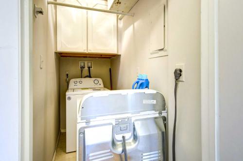 a small kitchen with a washing machine in a room at Raleigh Condo Near Campus and Museums! in Raleigh