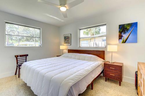 a bedroom with a large bed and two windows at Charming Sarasota Vacation Home Near Downtown in Sarasota
