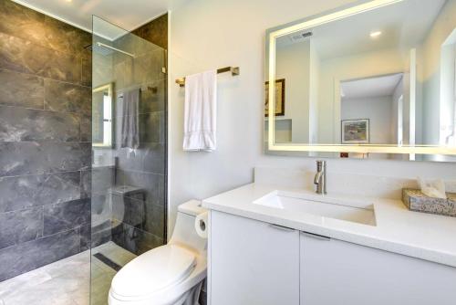 a bathroom with a toilet and a sink and a shower at Charming Sarasota Vacation Home Near Downtown in Sarasota