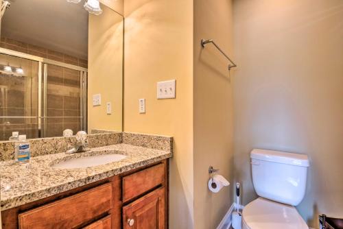 a bathroom with a sink and a toilet and a mirror at Smyrna Townhome, Close to Truist Park! in Smyrna