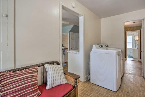 a living room with a washing machine and a couch at Rural Oswego Cottage on 50-Acre Orchard and Farm! in Oswego