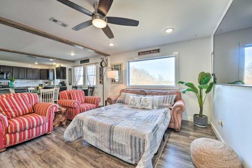 a living room with a bed and two chairs at Boho Mountain Home Escape, Walk to Marina! in Mountain Home