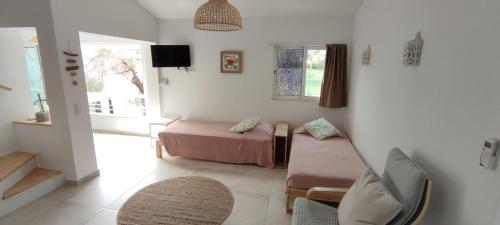 a living room with a couch and a bed at Cosy Beach Loft Pedras Del Rei in Pedras de El-Rei